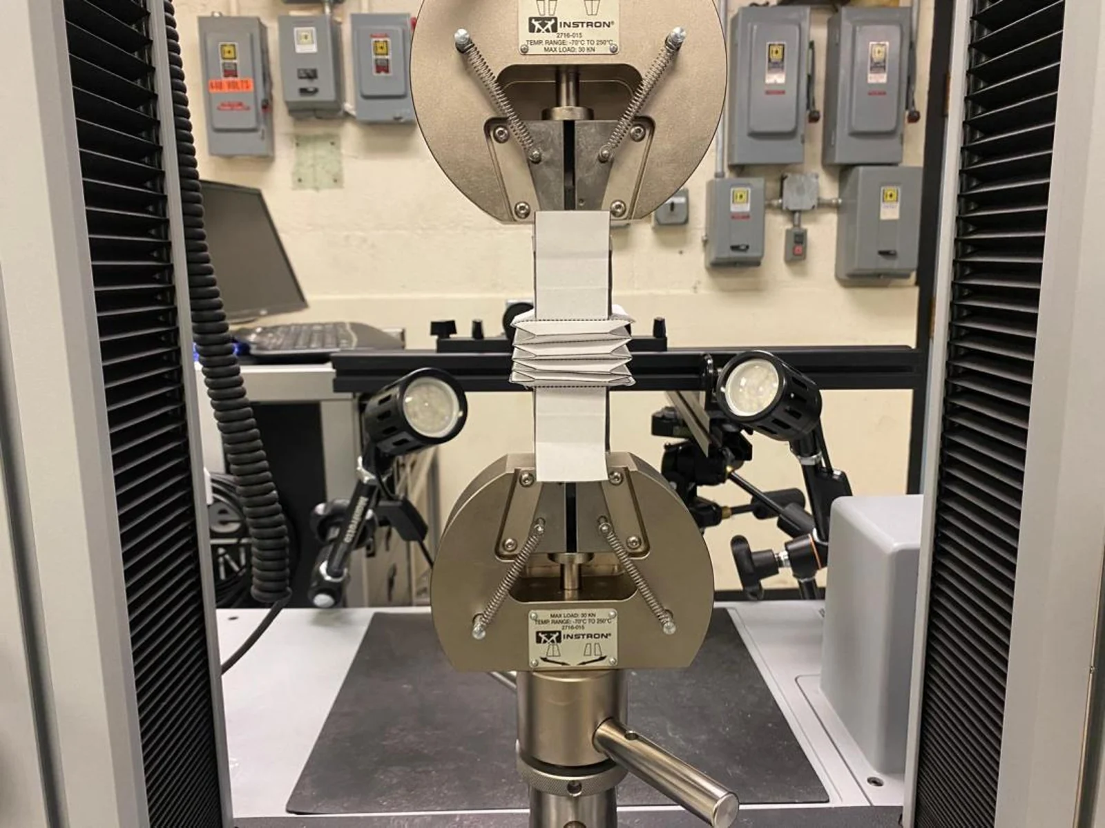 Folded paper bellows connected to printed test fixtures.